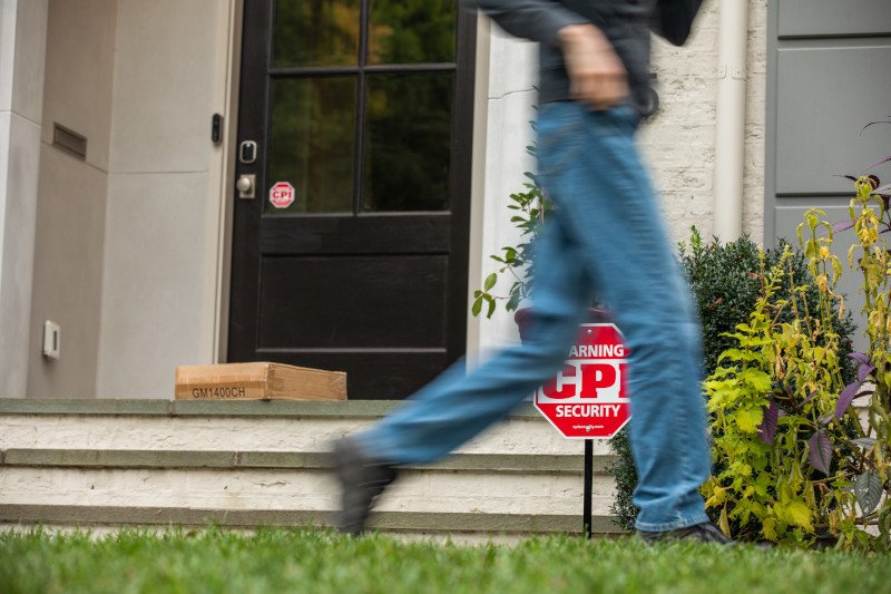 burglar running away from package left on doorstep after seeing CPI Security sign