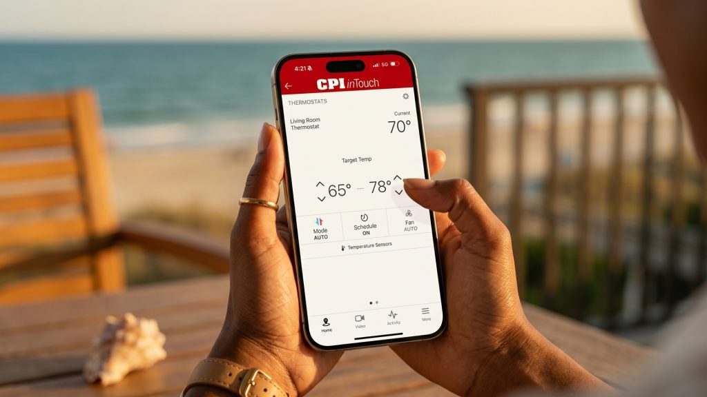 05_05_26_Best-out-of-town-temperature Hands holding phone with security app on screen