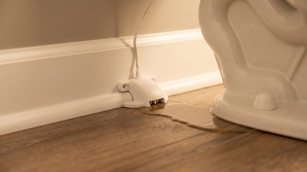 Smart water sensor installed next to toilet