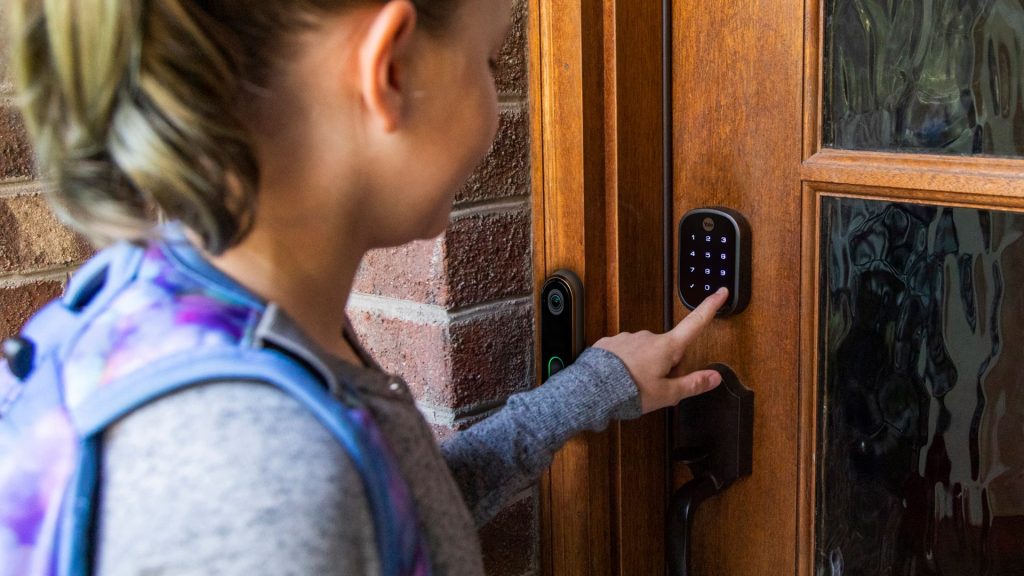 Kid pressing code into CPI Security smart door lock