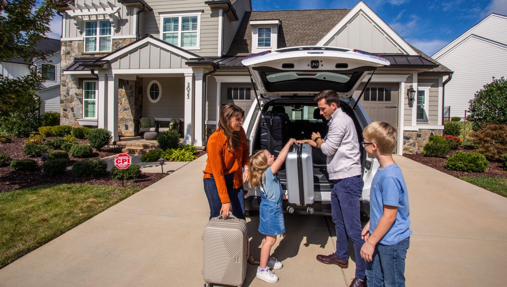 Family loading luggage in car