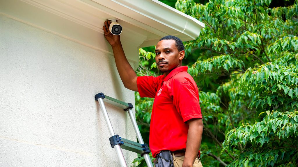 CPI Security Technician installs outdoor camera