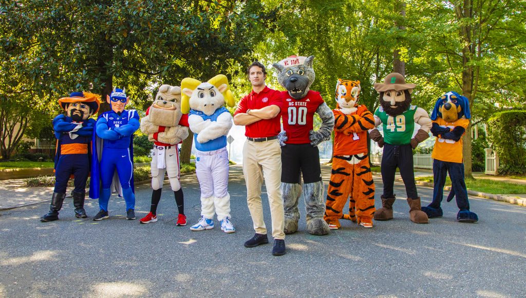 College mascots posing for photo with CPI Security tech