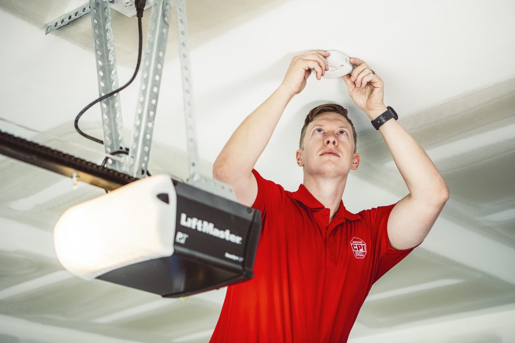 CPI Security tech installs Smart Garage Door Controller on ceiling