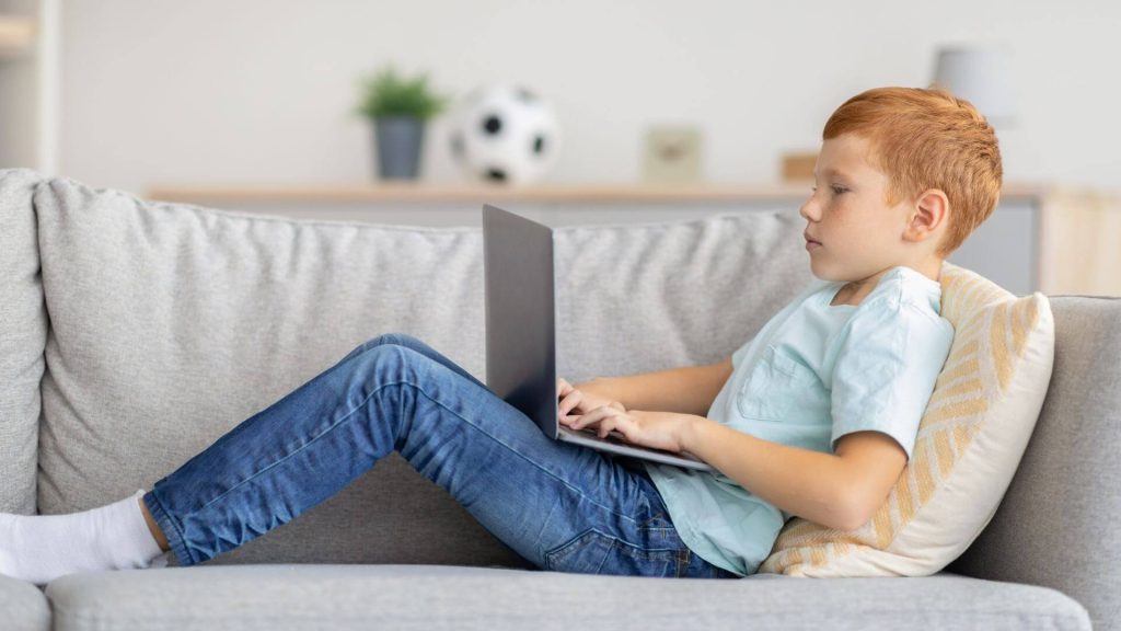 Boy looking at laptop
