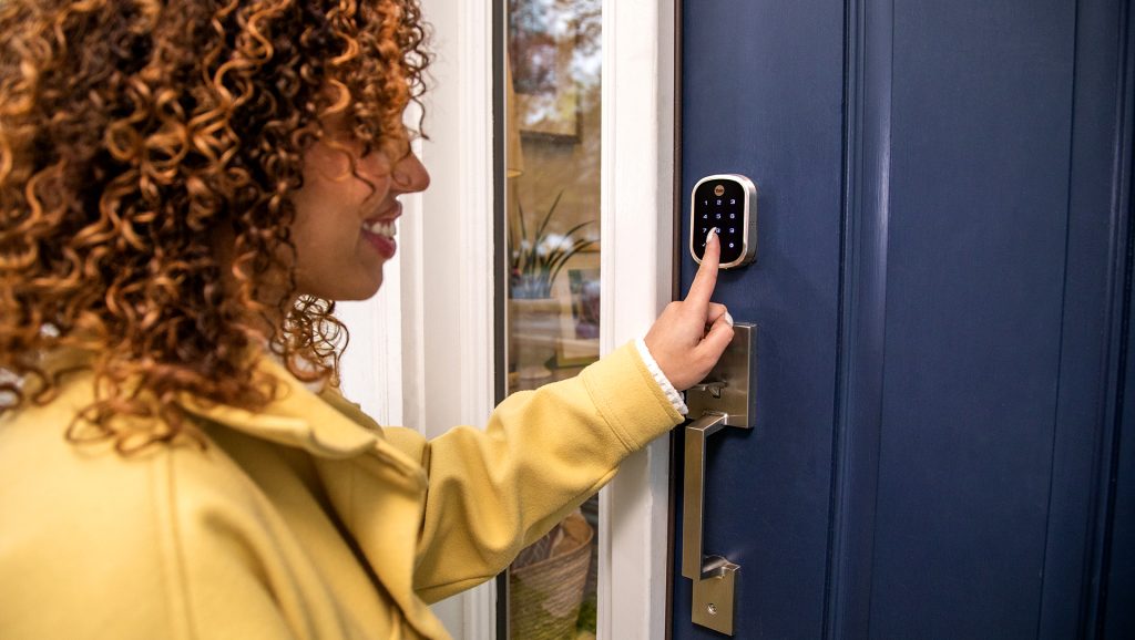 Woman pressing code into CPI Security smart door lock