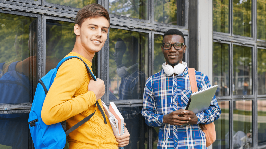 College students holding books and backpacks