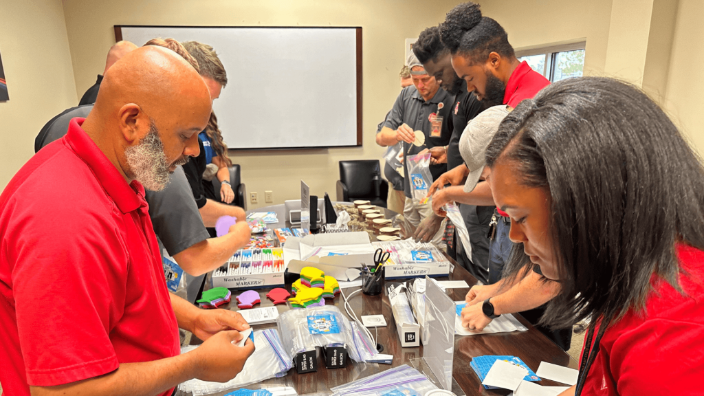 CPI Employees gather supplies for children summer camp