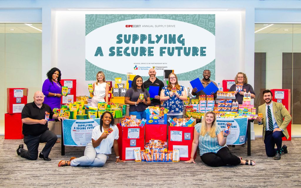 CPI Security employees donate school supply to children