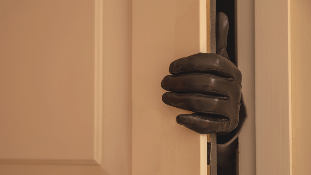 Gloved hand opening interior door ajar