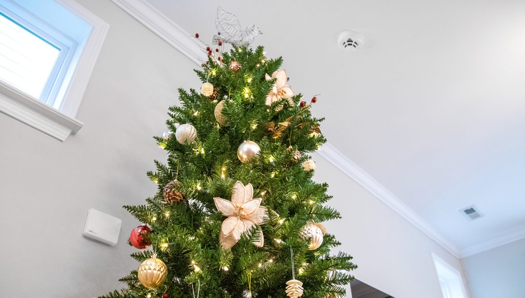 CPI Security heat detector mounted on ceiling next to Christmas tree