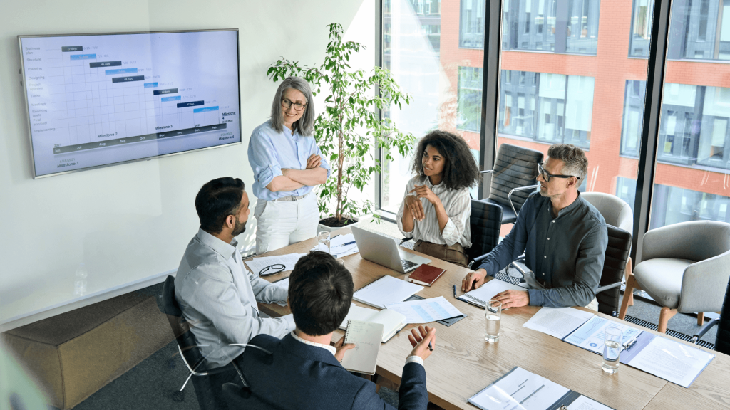 Employees in office meeting looking at charts