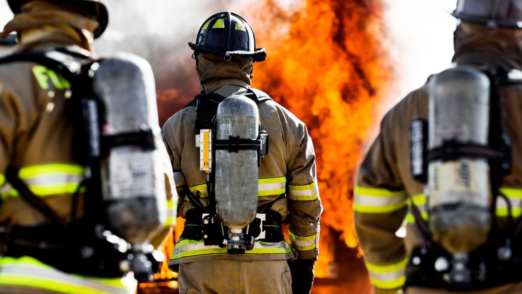 Firefighters walking towards fire