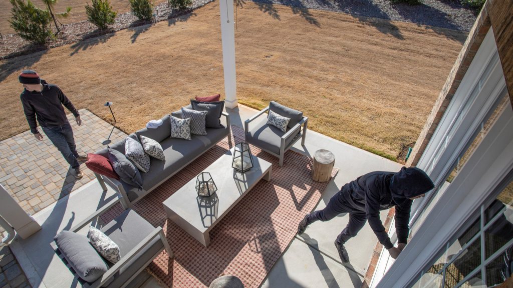 Burglar attempting to break into home from patio