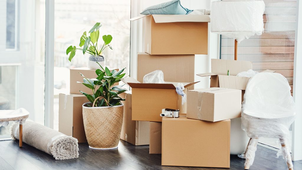 cpi-security-blog-packing-tips Moving boxes piled up in corner of room
