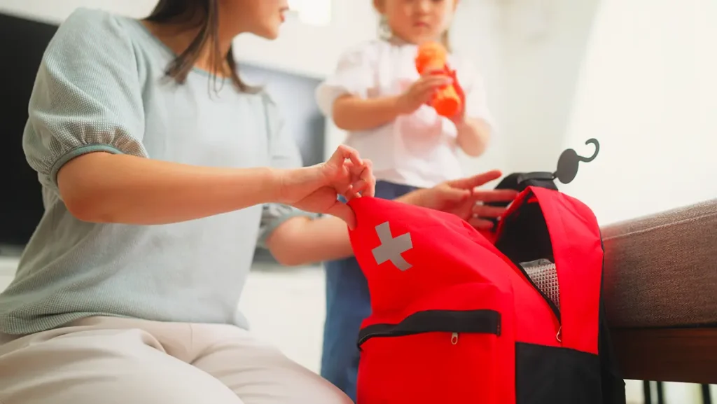 Woman packs emergency kit for natural disaster