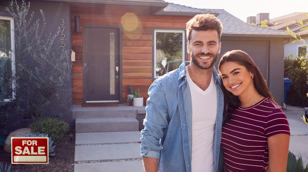 Couple in front of house for sale