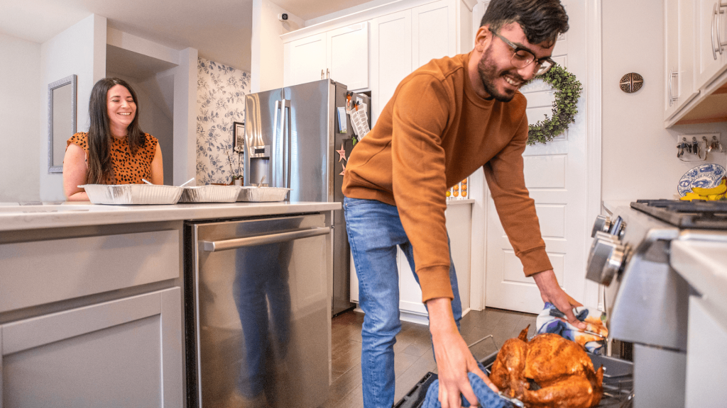 couple cooking a turkey in the kitchen