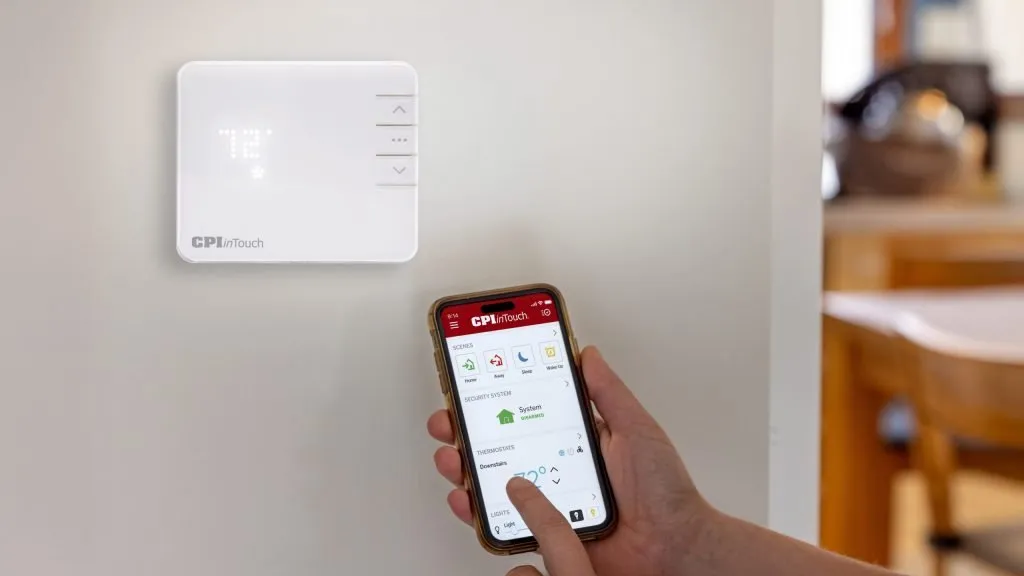 Person using inTouch app on iPhone to change thermostat temperature