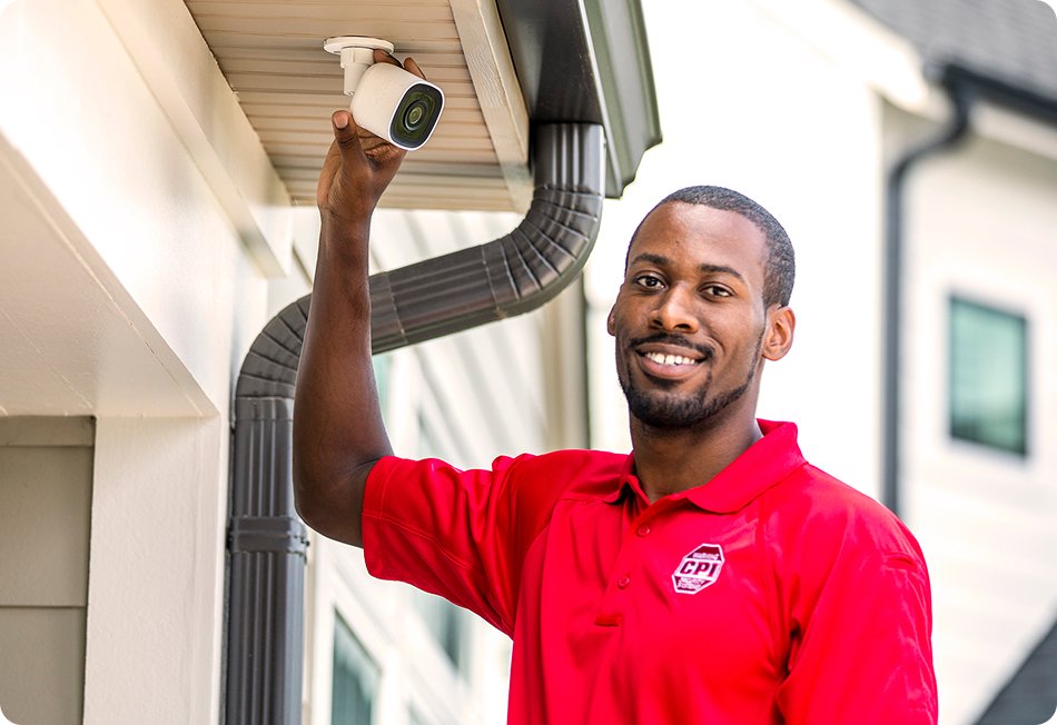 CPI Tech installing outdoor security camera on house