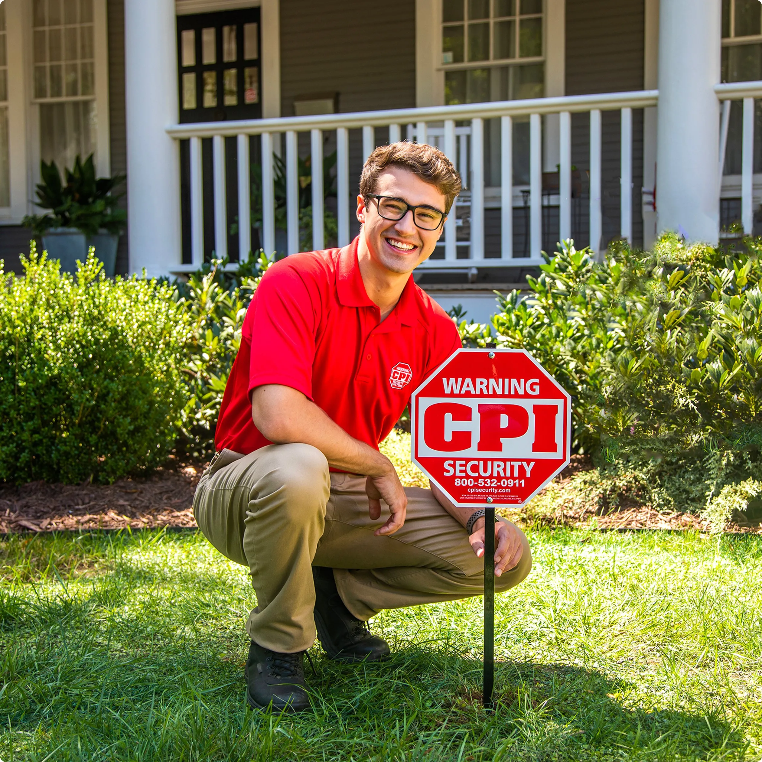 CPI Tech posing next to CPI Security yard sign