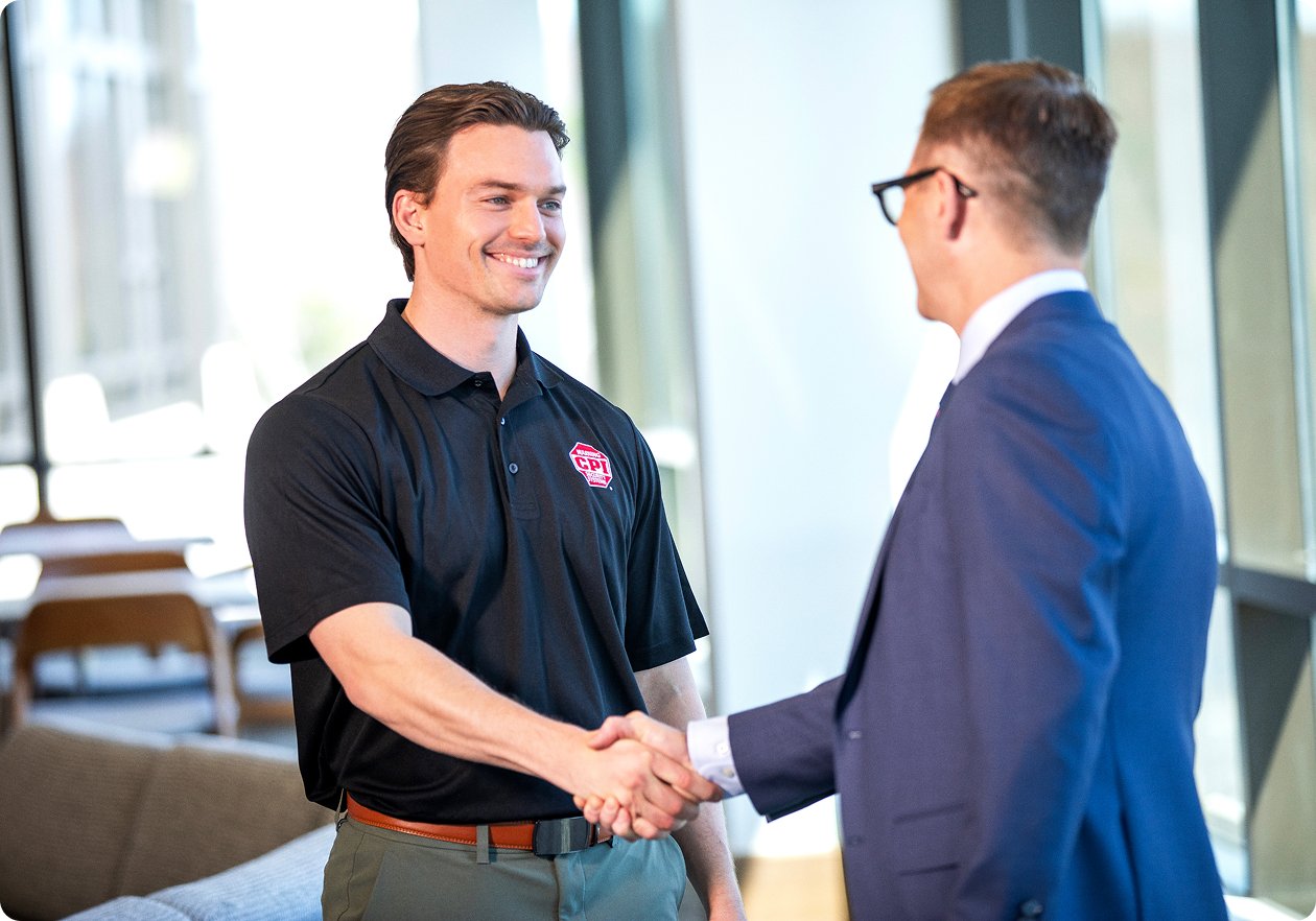CPI Security Sales Employee shakes hands with business client