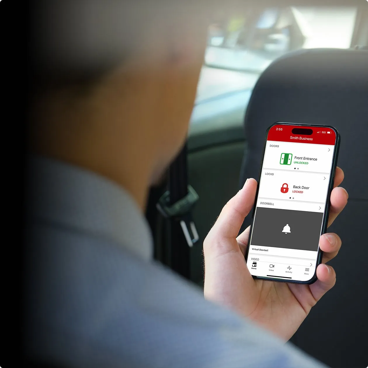 Person holding an iPhone displaying the inTouch app showing business dashboard
