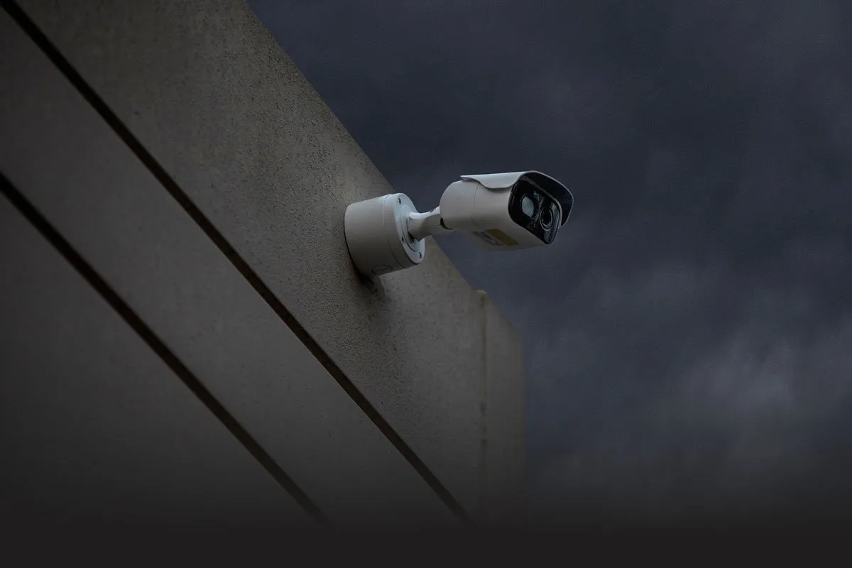 business-form-fade CPI security outdoor camera mounted on exterior of business