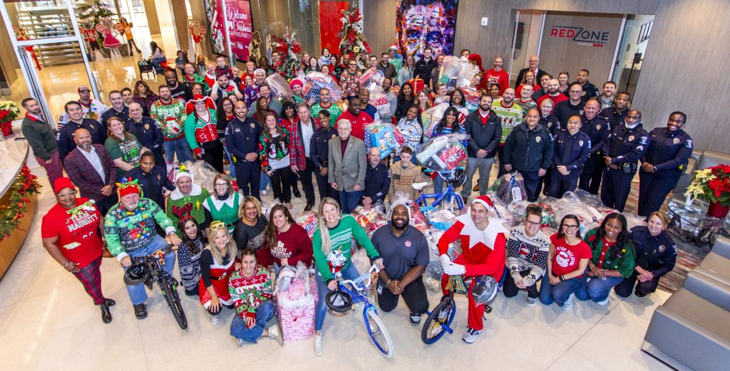 CPI Employees stand with donated presents for Christmas